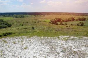 Ancient multimillion chalk mountains on the steppe surface of earth photo