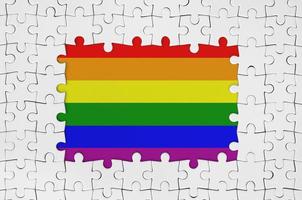 LGBT community flag in frame of white puzzle pieces with missing central part photo