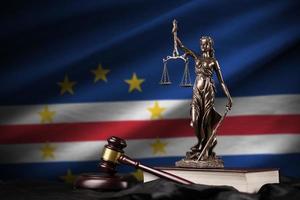 Cabo verde flag with statue of lady justice, constitution and judge hammer on black drapery. Concept of judgement and guilt photo