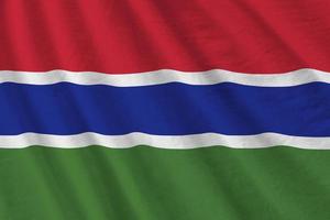 Gambia flag with big folds waving close up under the studio light indoors. The official symbols and colors in banner photo