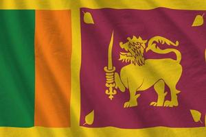 Sri Lanka flag with big folds waving close up under the studio light indoors. The official symbols and colors in banner photo