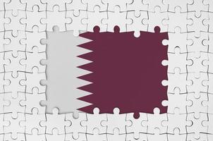 Qatar flag in frame of white puzzle pieces with missing central part photo