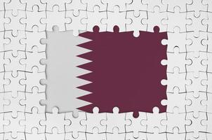 Qatar flag in frame of white puzzle pieces with missing central part photo