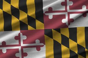 Maryland US state flag with big folds waving close up under the studio light indoors. The official symbols and colors in banner photo