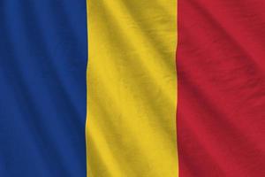 Romania flag with big folds waving close up under the studio light indoors. The official symbols and colors in banner photo