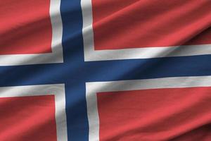 Norway flag with big folds waving close up under the studio light indoors. The official symbols and colors in banner photo