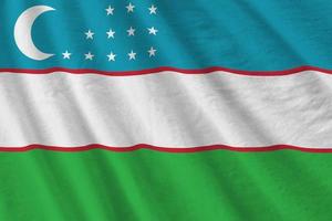 Uzbekistan flag with big folds waving close up under the studio light indoors. The official symbols and colors in banner photo