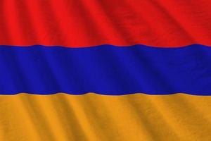 Armenia flag with big folds waving close up under the studio light indoors. The official symbols and colors in banner photo