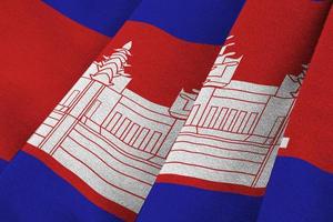 Cambodia flag with big folds waving close up under the studio light indoors. The official symbols and colors in banner photo