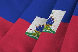 Haiti flag with big folds waving close up under the studio light indoors. The official symbols and colors in banner photo