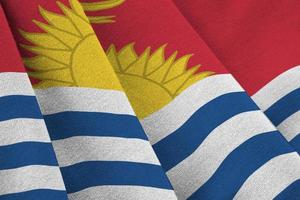 Kiribati flag with big folds waving close up under the studio light indoors. The official symbols and colors in banner photo