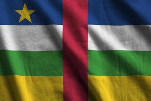 Central African Republic flag with big folds waving close up under the studio light indoors. The official symbols and colors in banner photo