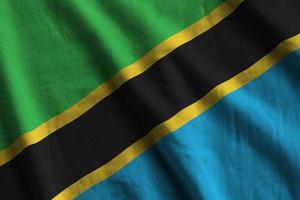 Tanzania flag with big folds waving close up under the studio light indoors. The official symbols and colors in banner photo