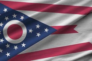 Ohio US state flag with big folds waving close up under the studio light indoors. The official symbols and colors in banner photo