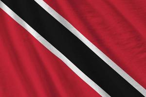 Trinidad and Tobago flag with big folds waving close up under the studio light indoors. The official symbols and colors in banner photo