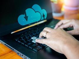 Human hand working on computer and cloud icon. Cloud computing concept, connect communication equipment  information and technology with cloud computing. photo