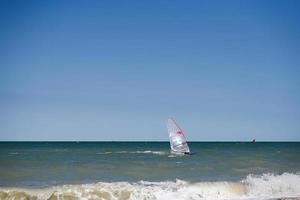 Windsurfer on a good riding waves at sea. photo