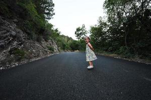 Baby girl run in mountain road of Nocera Umbra,  town and comune in the province of Perugia, Italy. photo