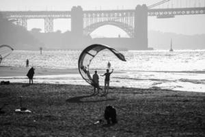 Kite on a beach mirrors the curve in the Golden Gate Bridge photo