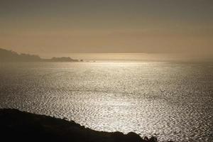 Dappled light reflects on the choppy water in an early morning image. photo