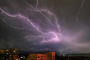 Amazing powerful lightning strikes over the sea and city, Varna. Bulgaria photo