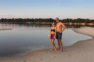 Couple at the Rio Negro in the Amazon of Brazil enjoying themselves late in the day photo