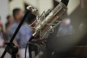 Live performance recording mic with children's background blur photo