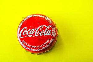 Ayutthaya, Thailand-25June2020- Coca-Cola Classic in a glass bottle and can on dark toned cement Background. Coca Cola, Coke is the most popular carbonated soft drink beverages sold around the world photo