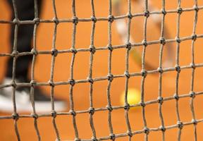 Tennis net on red clay closed tennis court photo