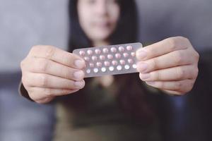 Women holding birth control pills photo