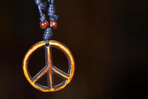 Wooden peace symbol attached to string necklace fairies love not war photo