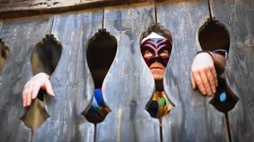 The mask of Arlecchino. Look between the wooden terrace photo