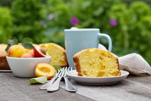 Freshly baked peach cake with tea photo