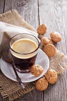 Black coffee in a glass with almond cookies photo