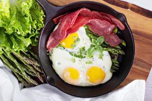 Baked eggs with asparagus and bacon photo