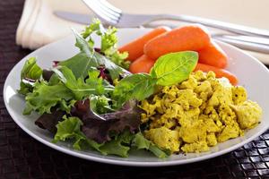 Scrambled tofu with salad leaves for breakfast photo