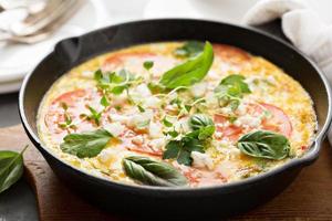 Frittata with tomatoes and feta cheese photo