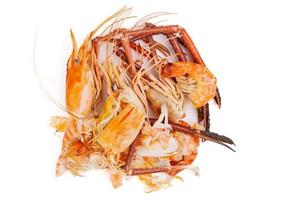 Shrimp heads and shrimp shells, food waste, leftovers, waste. Natural seafood. Lunch. Dinner isolated on white background. photo