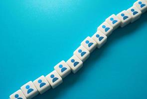 A chain of blocks with symbols of people. Human resources and work force. Staffing and recruiting candidates. Communication between employees. Building technological chains and working relationships. photo
