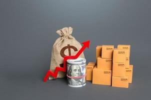 Boxes with a red arrow up and money. Increase in trade volumes, growth of purchasing power. Trade surplus, economic improvement. Fees and Tariffs, customs. High sales. Import and export. Added value photo