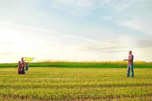 Family launches a kite in the field photo