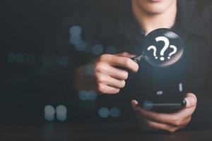 young man holding a magnifying glass Displays a search for information he is interested in through online websites,keyword search concept to find information from online websites,website link search photo