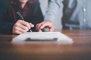 Businessman pointing and signing a business agreement,concept progress in development, financial efficiency and investment with business strategy for goals and opportunities in industry future photo