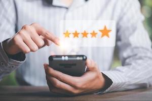 Male consumers rate their satisfaction and rate and review them online,Customer Experience Survey Concepts for Services and Products and Customer Engagement,Evaluation to check store quality photo