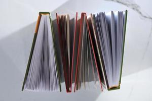 Top view of four books on white background photo