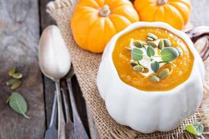 Pumpkin soup with cream, herbs and seeds photo