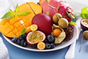 Exotic fruits on white plate photo