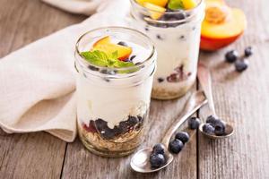 Layered breakfast parfait with granola and fruits photo