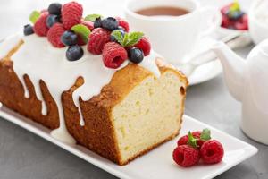 Yogurt pound cake with glaze and fresh berries photo