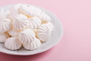 Meringue kisses cookies on a white plate photo